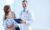 happy-doctor-holding-clipboard-with-patients_1098-2176